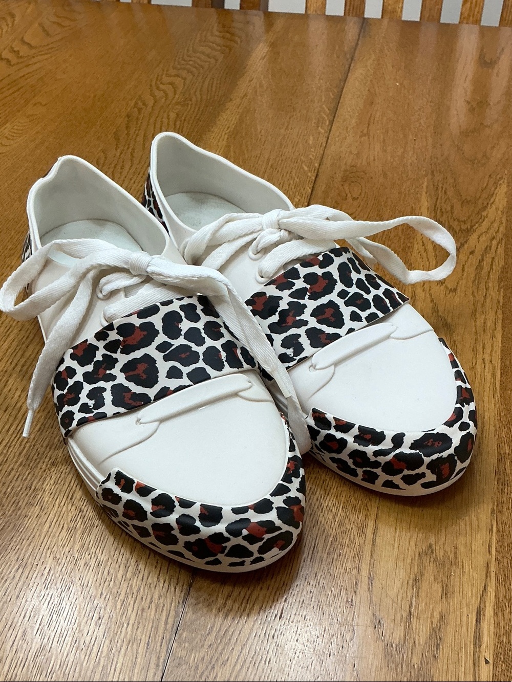 Woman’s Melissa white w/animal print tie shoe. Size 10. White laces. Barely worn